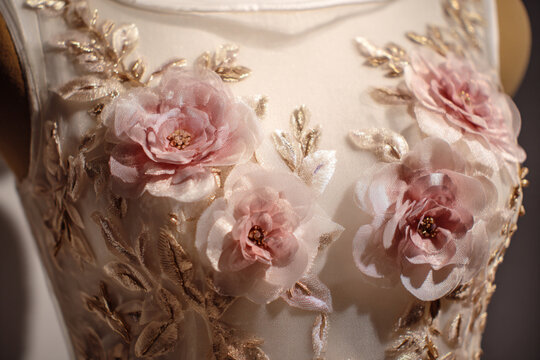 Elegant dress with floral embroidery displayed in a fashion boutique showcasing intricate design details - Powered by Adobe