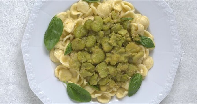 Orecchiette pasta with fava beans and basil.  A classic Italian dish called pasta e fave or pasta con fave. 