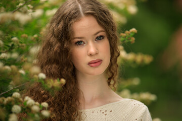 Portrait of beautiful young girl in park in spring