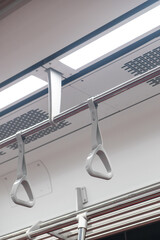 Hand grip inside the train of SRT Dark Red Line. It is a rapid transit line operated as part of the MBTA subway system from Bangkok to Rangsit