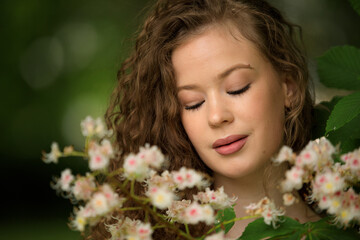 Fototapeta premium Portrait of beautiful young girl in park in spring