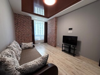Modern living room with brick accent walls and TV