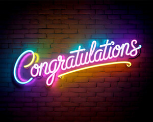 Glowing Neon “Congratulations” in Cursive Font on Dark Brick Wall