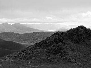 Overlooking rugged ridge in Coomloughra Horseshoe, Ireland, with layers of mountains receding into...