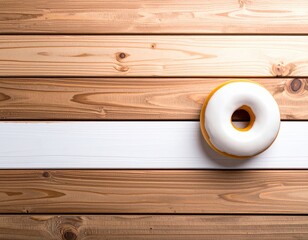 Minimalist composition of a white glazed doughnut with yellow border on a wooden surface background with horizontal planks in natural light
