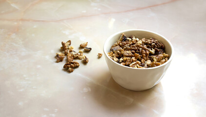 Walnuts in a white bowl on a table