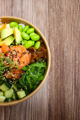 Top View of Salmon Poke Bowl on Wooden Table