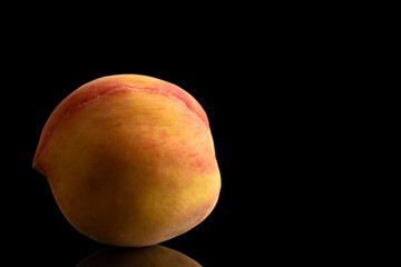 Juicy peaches isolated on black background, close-up.