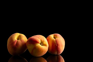 Juicy peaches isolated on black background, close-up.