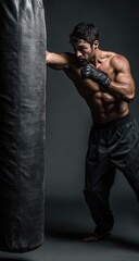 Man punching heavy bag in gym workout