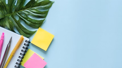 Colorful stationery items arranged on a light blue background.