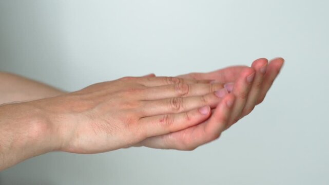 Man clapping with hands on white background.
Hand clapping and applause.
Close-up of male hands clapping during performance