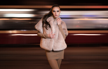 Portrait of beautiful young girl in at night in city