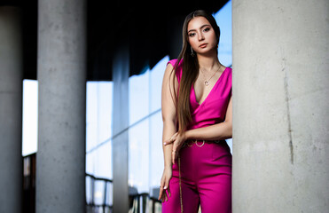 Portrait of beautiful young girl at city center among office buildings
