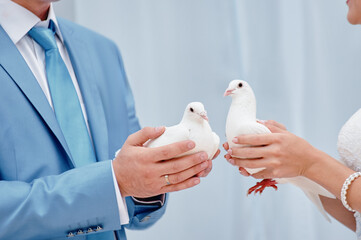 Couple Holding White Doves During Wedding Ceremony Symbolizing Peace and Love