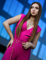 Portrait of beautiful young girl at city center among office buildings