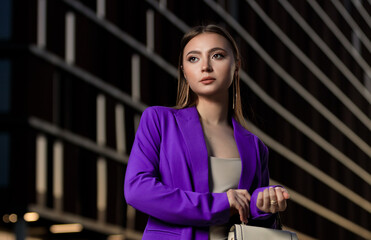 Portrait of beautiful young girl at city center among office buildings