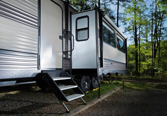 Slide out extended in a camper trailer in a forested campground