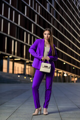 Portrait of beautiful young girl at city center among office buildings