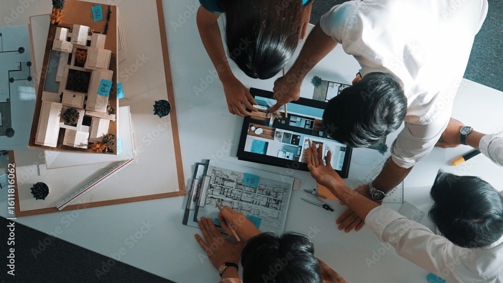 Poster top down view of architect engineer team discussing and point at tablet display construction at tabl