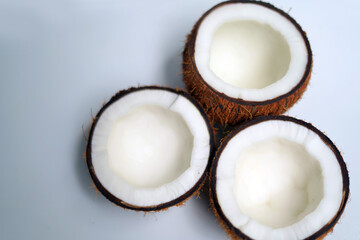 Rustic Brown Coconut Lying on White Table.