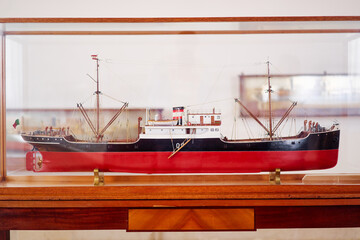 Detailed Model of a Vintage Red and Black Ship in Wooden Display Case