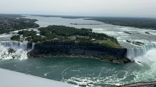 PAN SHOT Rainbow Bridge, the American, Bridal Veil, and Horseshoe Falls as seen from the Skylon Tower. Niagara Falls is a collective name for a group of three waterfalls situated on the Niagara River.