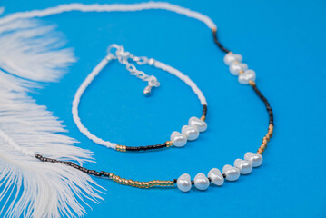 Beautiful handmade necklace and braclet on background