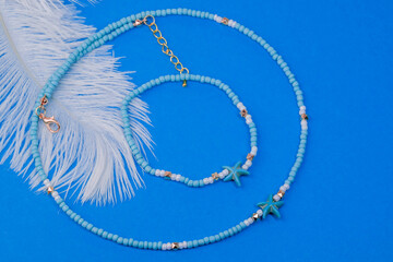 Beautiful handmade necklace and braclet on background