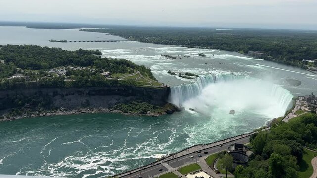 PAN SLOW Rainbow Bridge, the American, Bridal Veil, and Horseshoe Falls as seen from the Skylon Tower. Niagara Falls is a collective name for a group of three waterfalls situated on the Niagara River.