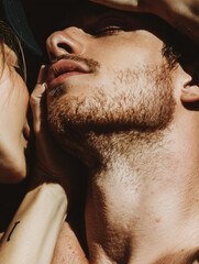 A photo that is a close up of a man and woman almost kissing, you can see their lips almost touching