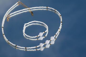 Beautiful handmade necklace and braclet on background