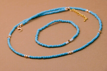 Beautiful handmade necklace and braclet on background