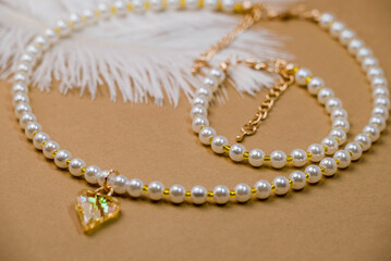 Beautiful handmade necklace and braclet on background