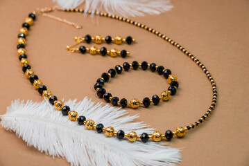 Beautiful handmade necklace and braclet on background