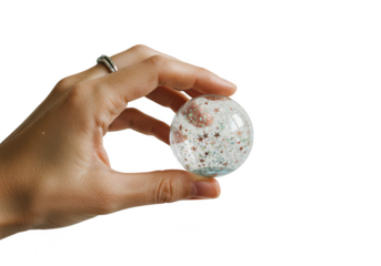 Hand holding a glittery snow globe with stars inside isolated on transparent background