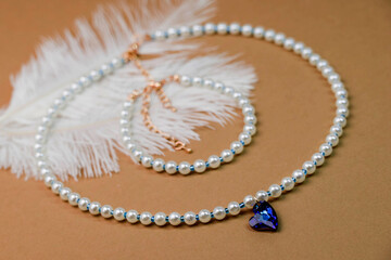 Beautiful handmade necklace and braclet on background