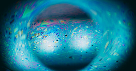 Bubble blur planet. Ink spill. Neon color fluid mix glowing sphere. Cosmic globe gasoline blue...