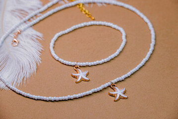 Beautiful handmade necklace and braclet on background