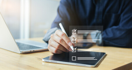close up businessman hand use stylus to check online questionnaire survey from website to rate score and share aspect of audience after complete from seminar for business corporation concept