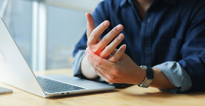 close up employee man massage on his hand and arm for relief pain from hard working ,carpal tunnel syndrome concept