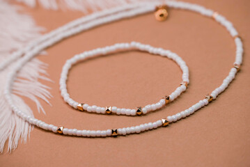 Beautiful handmade necklace and braclet on background