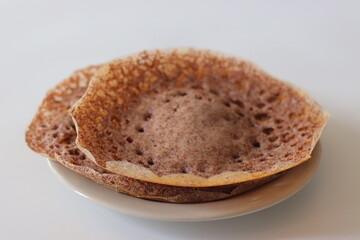 Ragi Appam, Freshly cooked Appam with lacy edges and soft center, made from fermented finger millet...