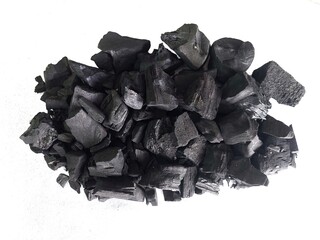 Natural wood charcoal is traditional charcoal made using hardwood isolated on a white background....