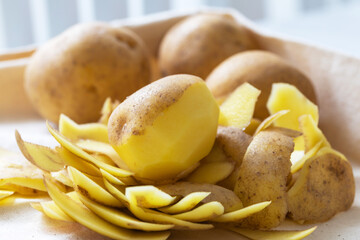 Potatoes lying on peeled potatoes.