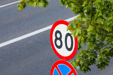 Close-up view of 30 km/h speed limit and no parking traffic signs on European street