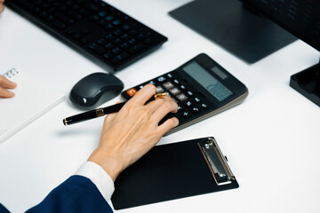 Cropped hands businessman with coworker calculating with calculator manual's financial and...