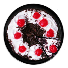 Classic black forest cake on a black plate. Top view isolated on a white background.