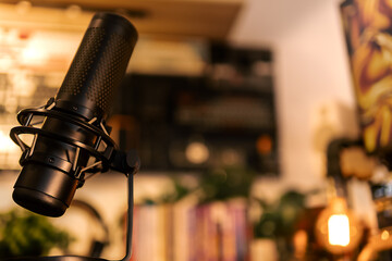 Professional microphone in warm light home studio, ideal for podcast or voice recording visuals