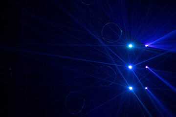 Blue and purple beams in dark background.